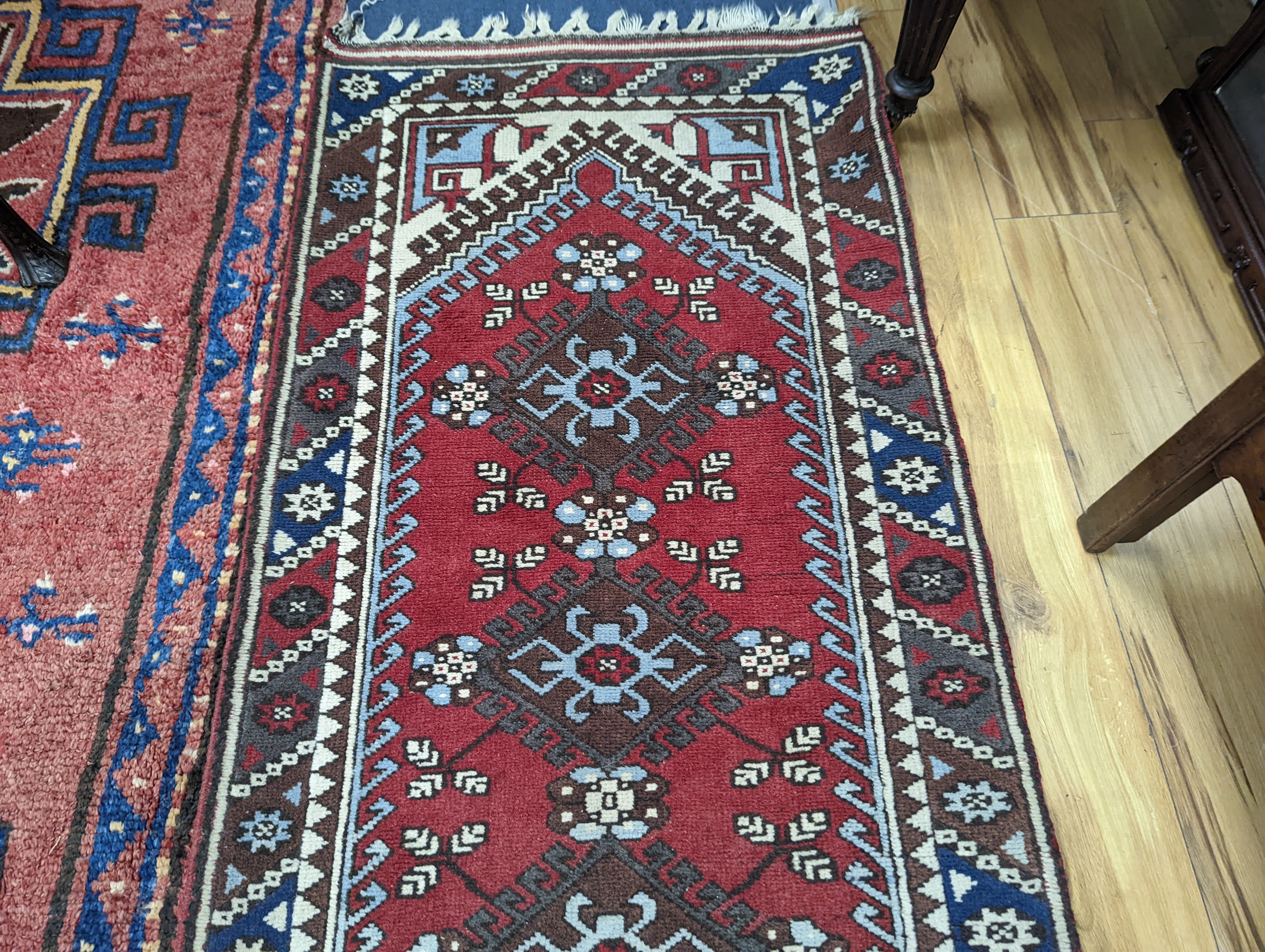 A Caucasian design red ground runner, 300 x 78cm